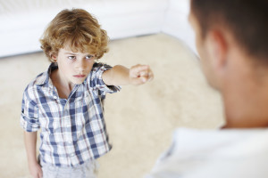 A young boy reprimanding his father at home